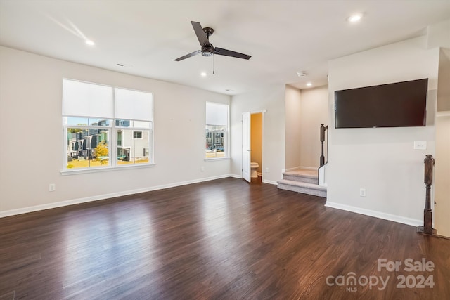 unfurnished living room with dark wood-type flooring and ceiling fan