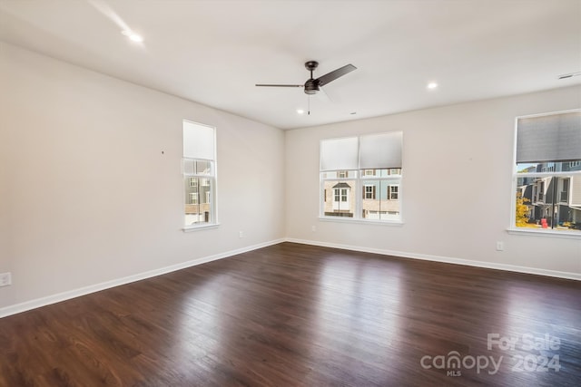 spare room featuring dark hardwood / wood-style floors and ceiling fan