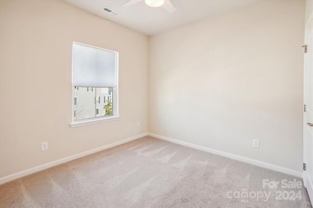 carpeted spare room with ceiling fan