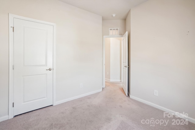 empty room featuring light colored carpet