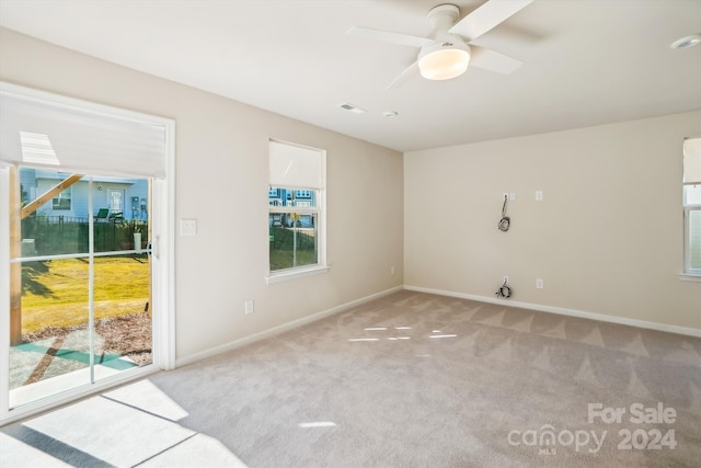 spare room with light carpet and ceiling fan