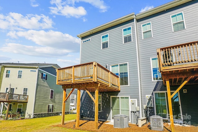 back of house with a yard, central air condition unit, and a deck