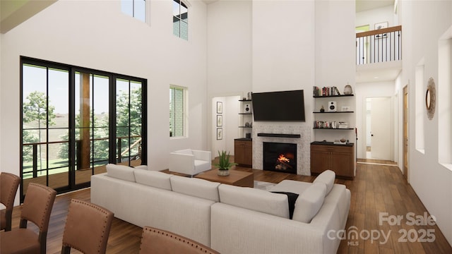 living room featuring a towering ceiling and dark wood-type flooring