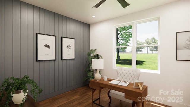 office space featuring wooden walls, ceiling fan, and hardwood / wood-style flooring