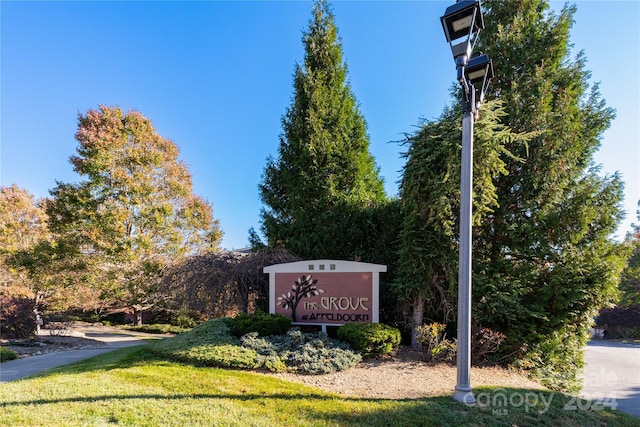 community / neighborhood sign featuring a yard