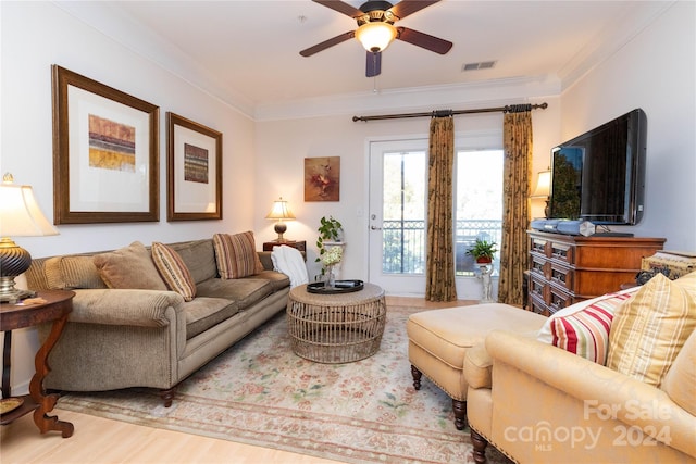 living room with ceiling fan, crown molding, and hardwood / wood-style floors