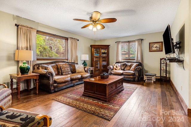 living room featuring ceiling fan, a textured ceiling, and hardwood / wood-style floors