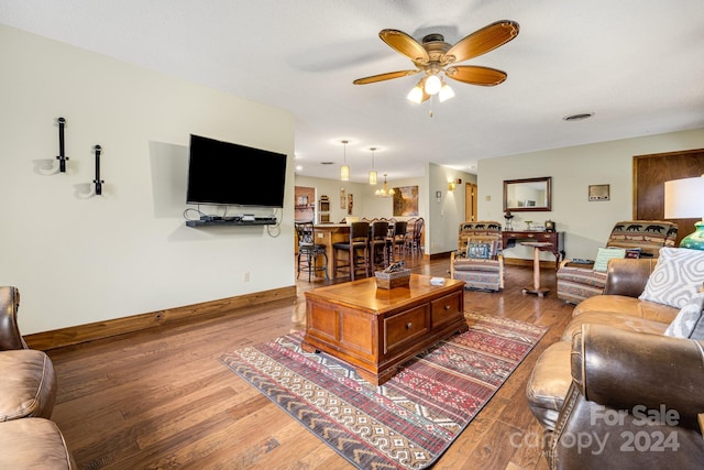 living room with wood-type flooring and ceiling fan