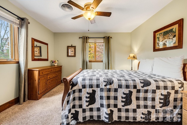 bedroom featuring ceiling fan and light carpet