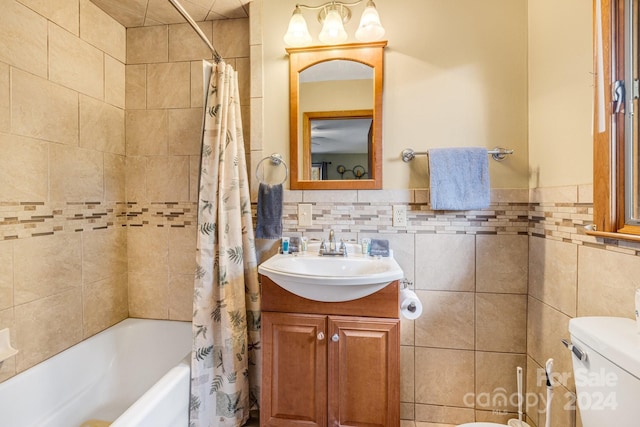 full bathroom featuring vanity, toilet, tile walls, and shower / tub combo with curtain