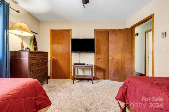 carpeted bedroom featuring a textured ceiling