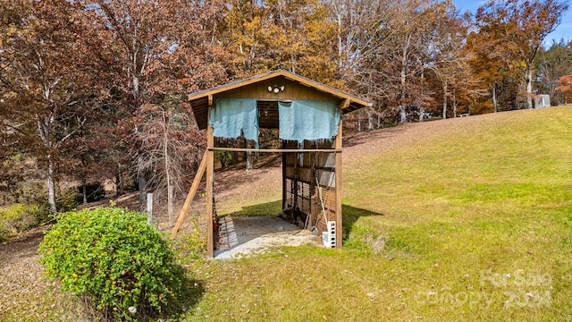 view of outbuilding with a lawn