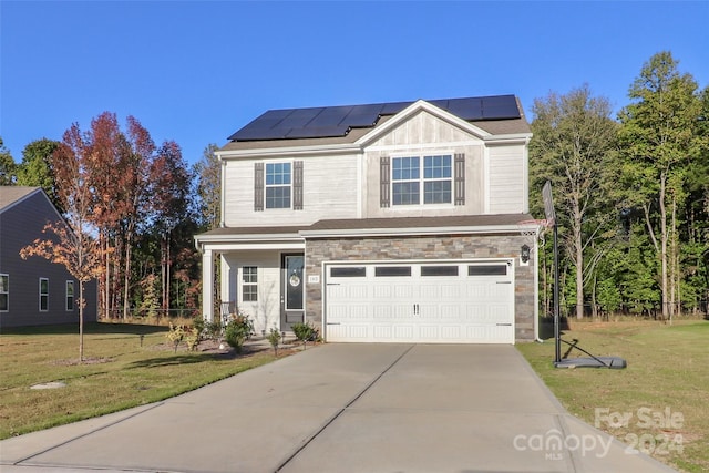 view of front of house featuring a front yard, solar panels, and a garage