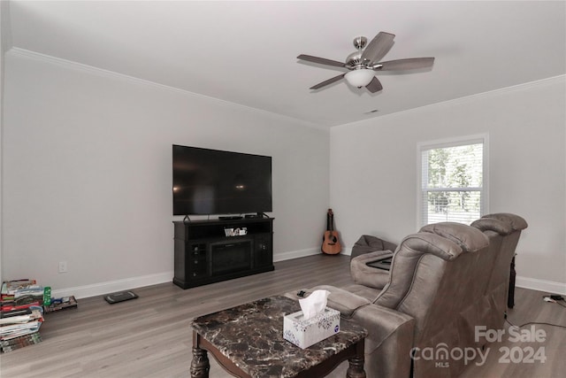 living room featuring ornamental molding, hardwood / wood-style flooring, and ceiling fan