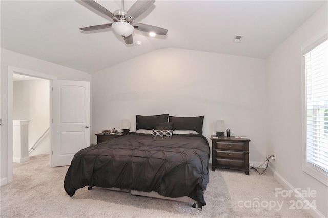 carpeted bedroom with multiple windows, lofted ceiling, and ceiling fan