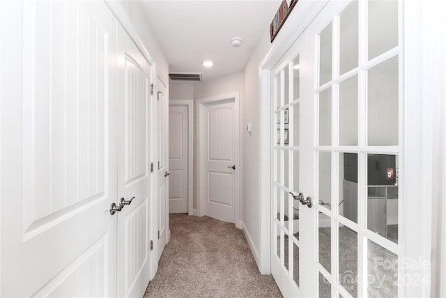 corridor with light colored carpet