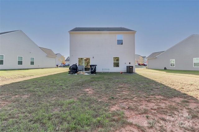 rear view of house featuring a patio, cooling unit, and a lawn