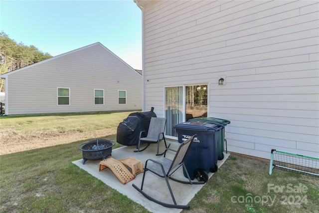 view of patio with a fire pit and a grill