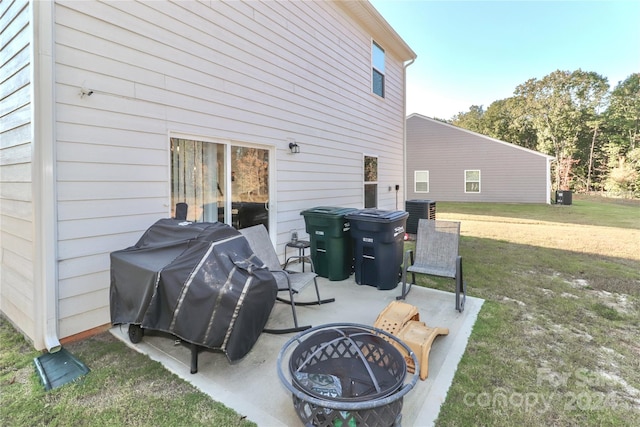 view of patio featuring an outdoor fire pit, central AC, and grilling area