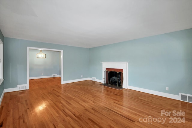 unfurnished living room featuring hardwood / wood-style flooring