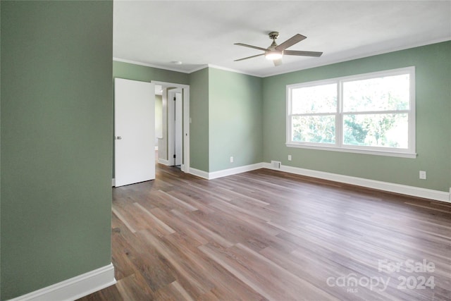 spare room with crown molding, hardwood / wood-style flooring, and ceiling fan