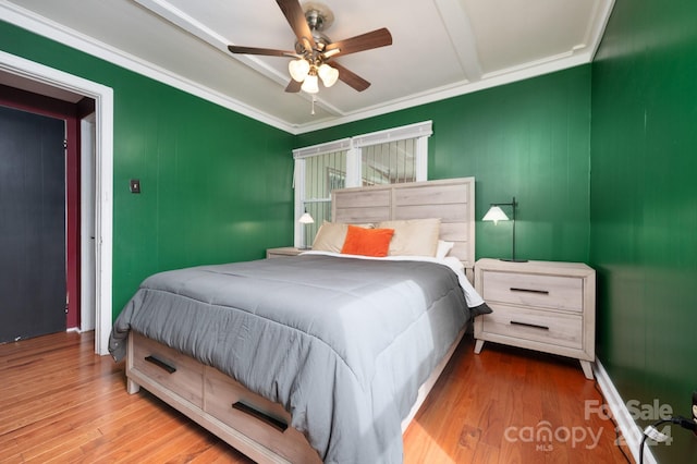 bedroom with ornamental molding, light hardwood / wood-style flooring, and ceiling fan