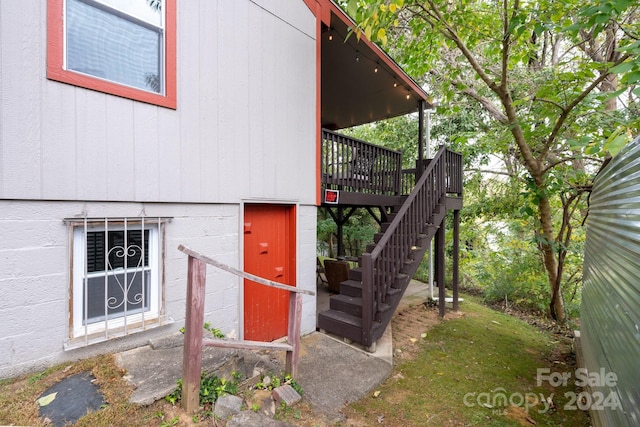 view of exterior entry with a deck