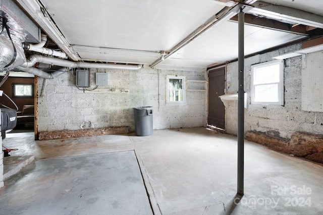 basement featuring a wealth of natural light and electric panel