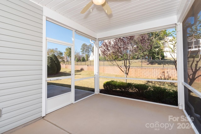 unfurnished sunroom with ceiling fan