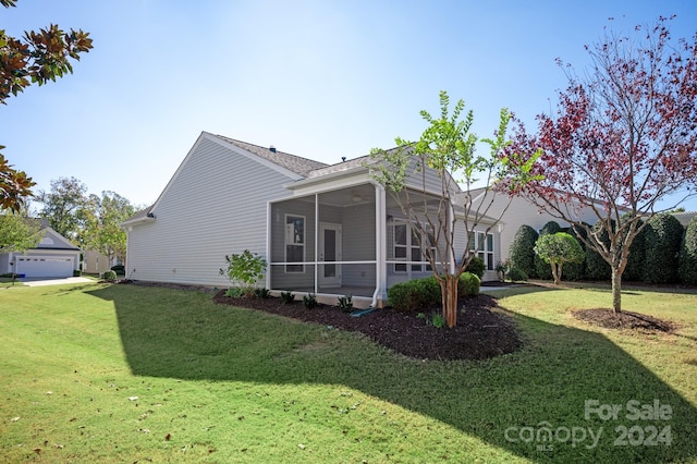 view of side of home featuring a lawn and a sunroom