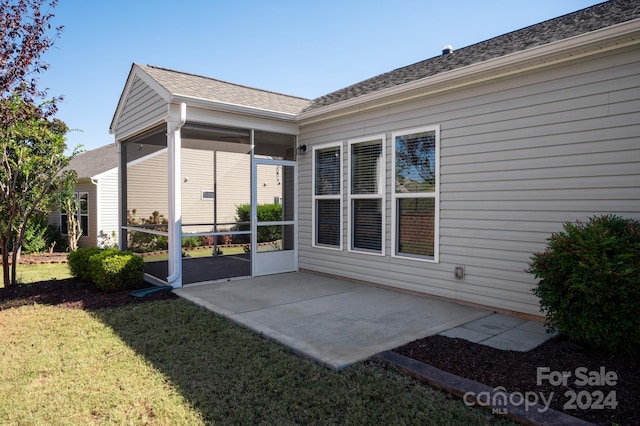 rear view of property with a patio area and a yard