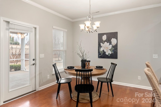 dining room featuring crown molding, a chandelier, and hardwood / wood-style flooring