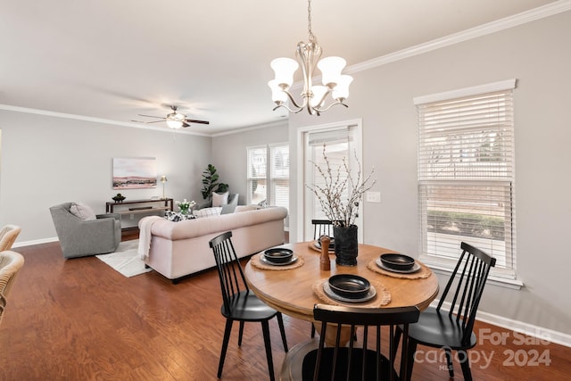 dining space with ceiling fan with notable chandelier, dark hardwood / wood-style flooring, and crown molding