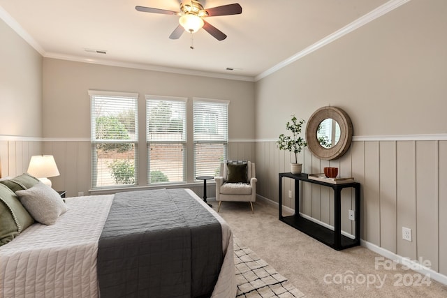 bedroom featuring ceiling fan, ornamental molding, and light carpet