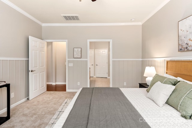 bedroom featuring light colored carpet and crown molding