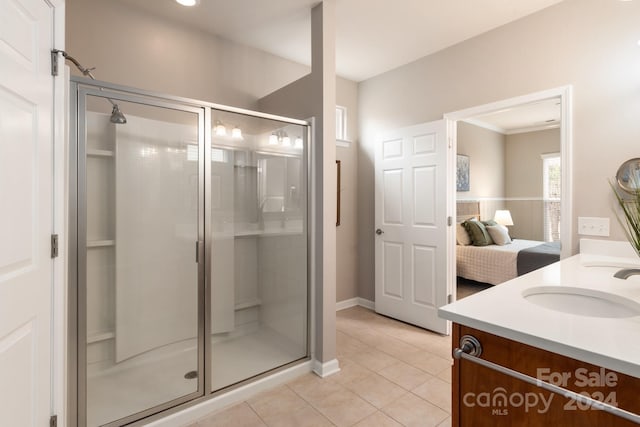 bathroom featuring tile patterned floors, vanity, and an enclosed shower