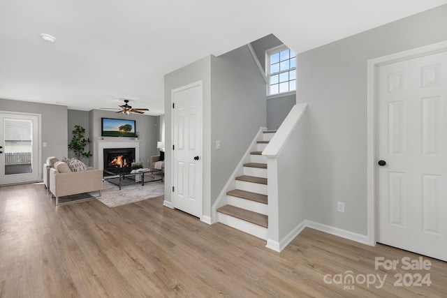 stairs featuring hardwood / wood-style flooring, plenty of natural light, and ceiling fan