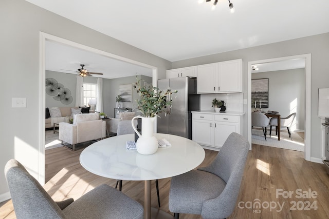 dining area featuring hardwood / wood-style flooring and ceiling fan