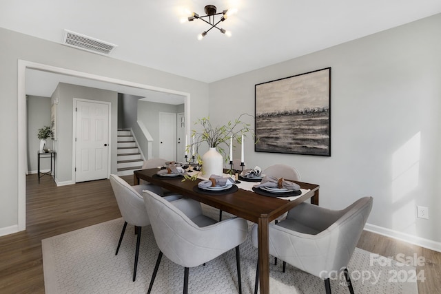 dining room featuring a notable chandelier and dark wood-type flooring