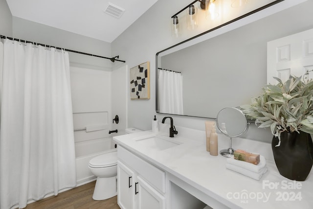 full bathroom with vanity, toilet, shower / tub combo with curtain, and hardwood / wood-style floors