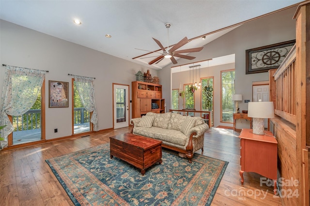 living room with ceiling fan, a healthy amount of sunlight, and light wood-type flooring