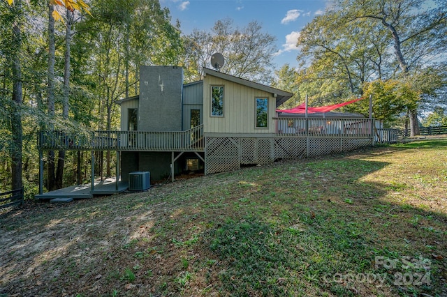 back of property featuring central AC, a yard, and a deck