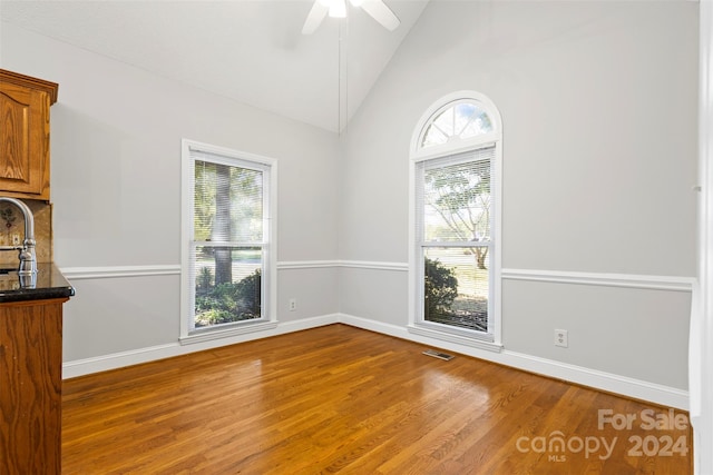 interior space featuring wood-type flooring, high vaulted ceiling, and ceiling fan