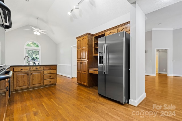 kitchen with dark wood-type flooring, vaulted ceiling, stainless steel appliances, and ceiling fan