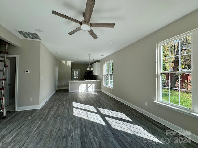 unfurnished living room featuring dark hardwood / wood-style floors and ceiling fan