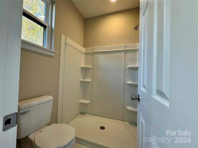 bathroom featuring toilet and walk in shower