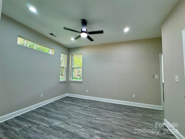 spare room featuring ceiling fan and dark hardwood / wood-style flooring