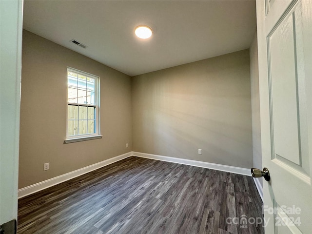 spare room featuring dark wood-type flooring