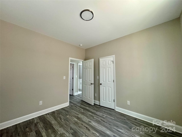 unfurnished bedroom featuring dark hardwood / wood-style flooring