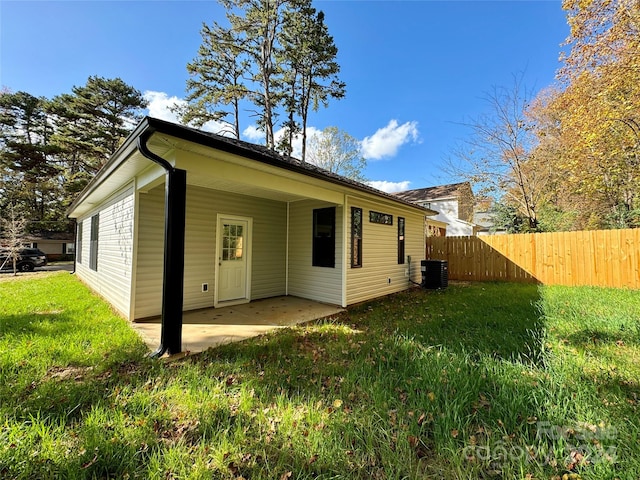 exterior space featuring a yard, a patio, and central AC unit